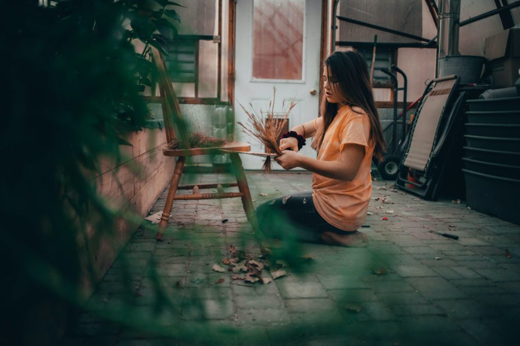 Young girl working on homeschooling project in greenhouse at home