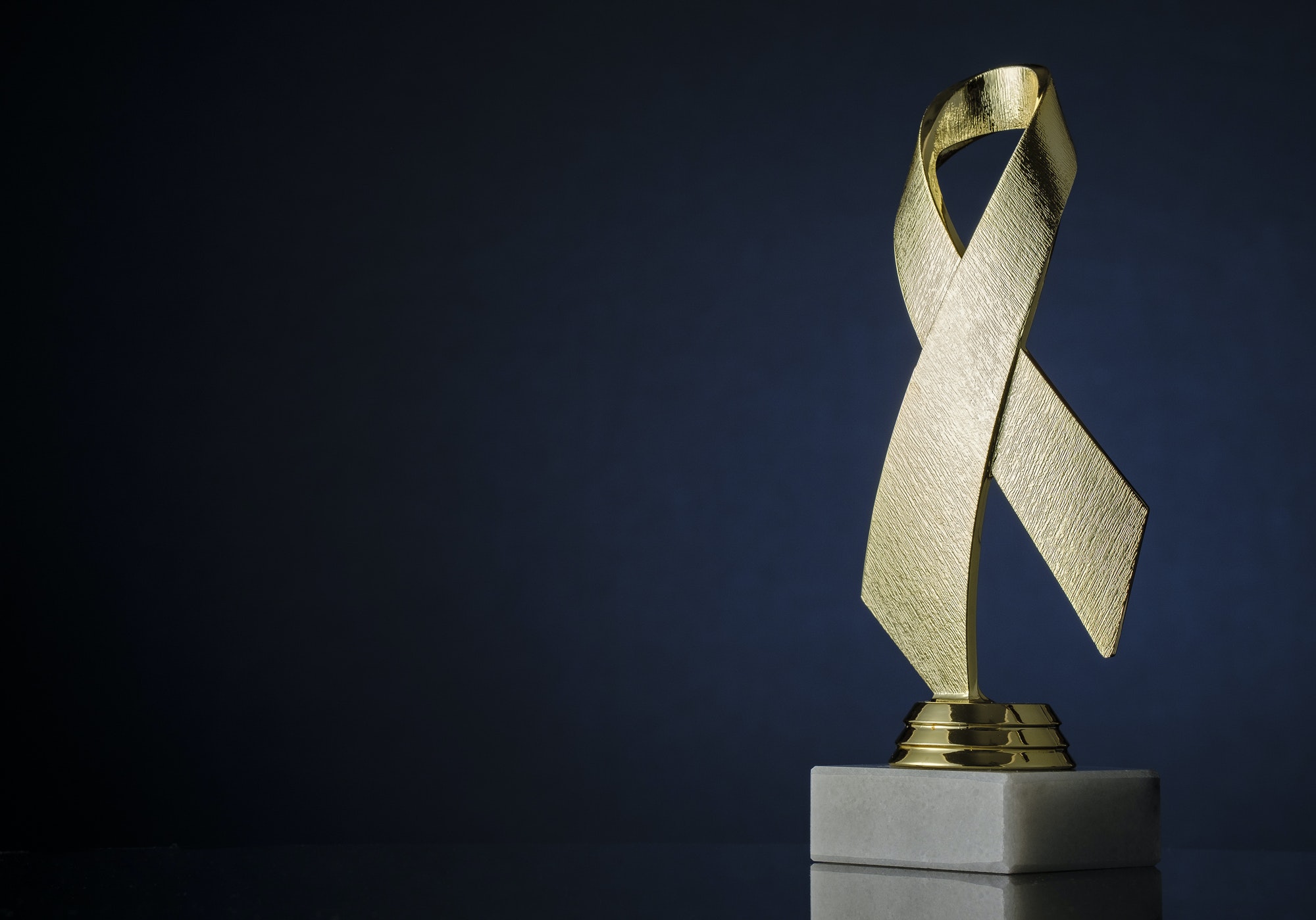 Symbolic textured gold ribbon trophy award